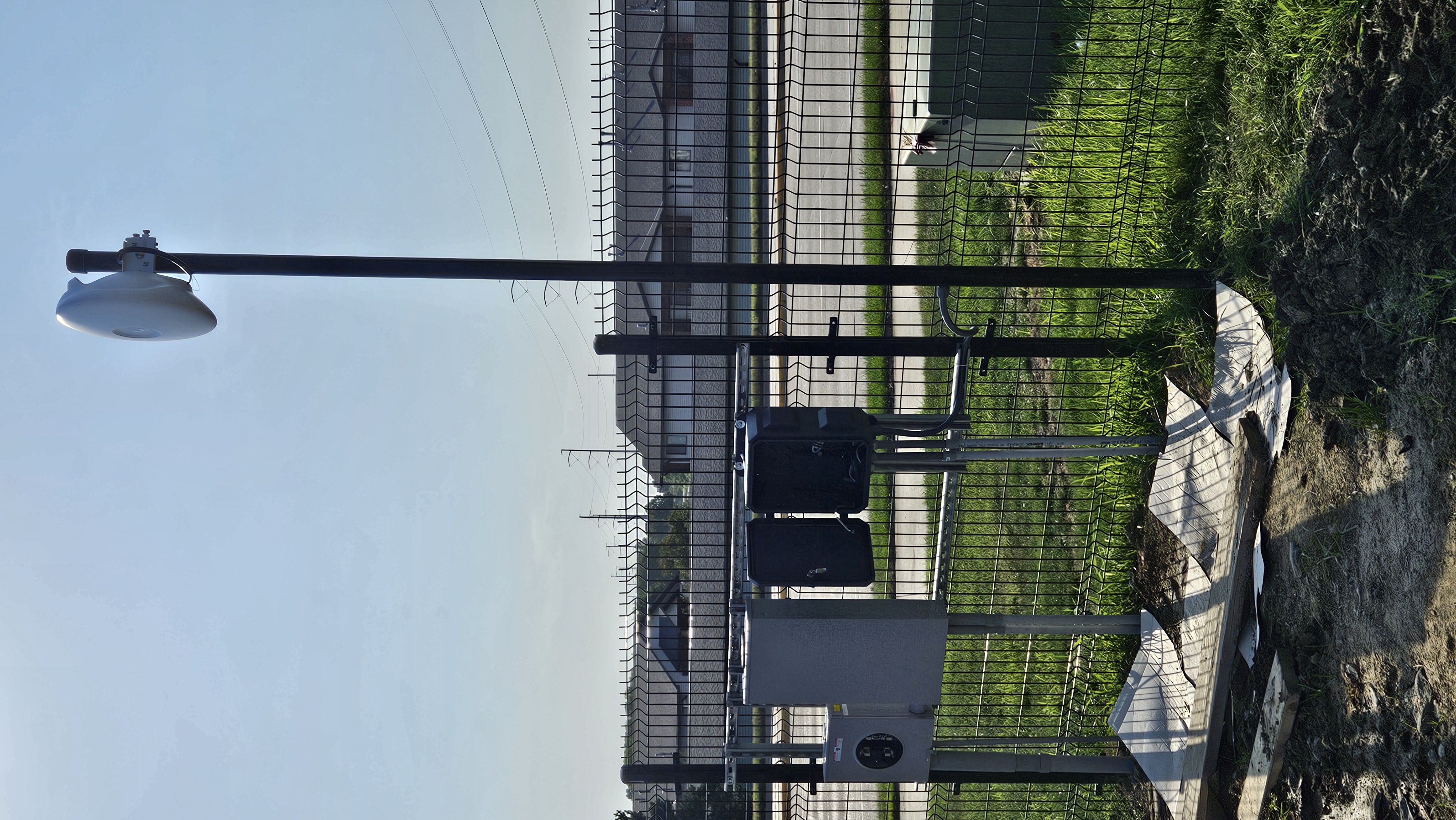 Wireless bridge and junction boxes on pole at perimeter fence for campus connectivity